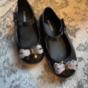 Mini Melissa Glossy Black Dress Shoes with Metallic Bow